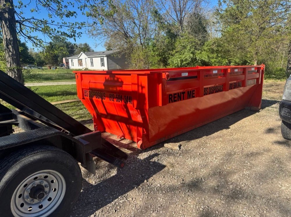 Dumpster placed on a rural gravel driveway